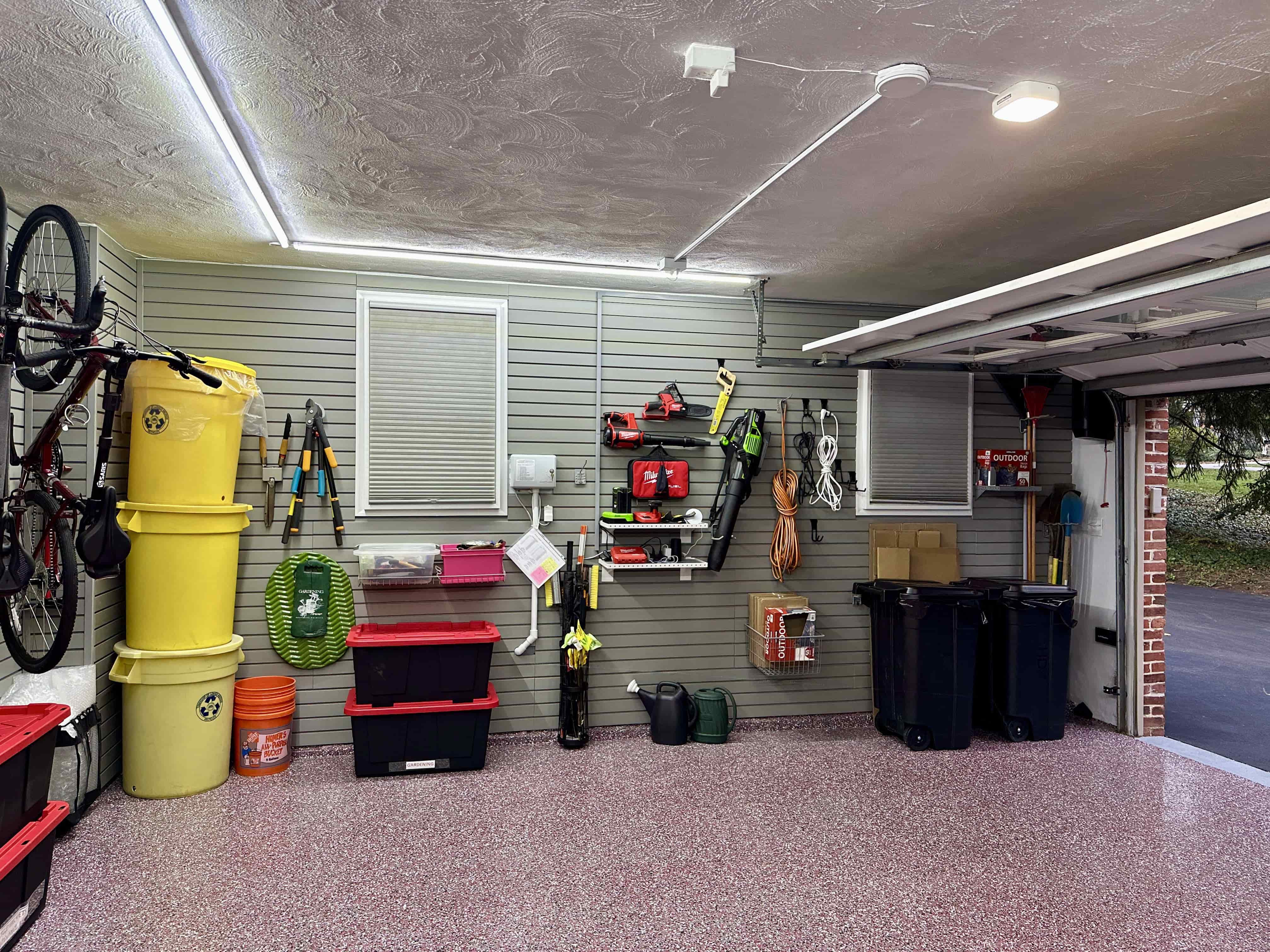 Recycling bins stacked neatly. Even everyday items have a dedicated spot. The system handles the boring stuff too so your garage stays tidy without extra effort.