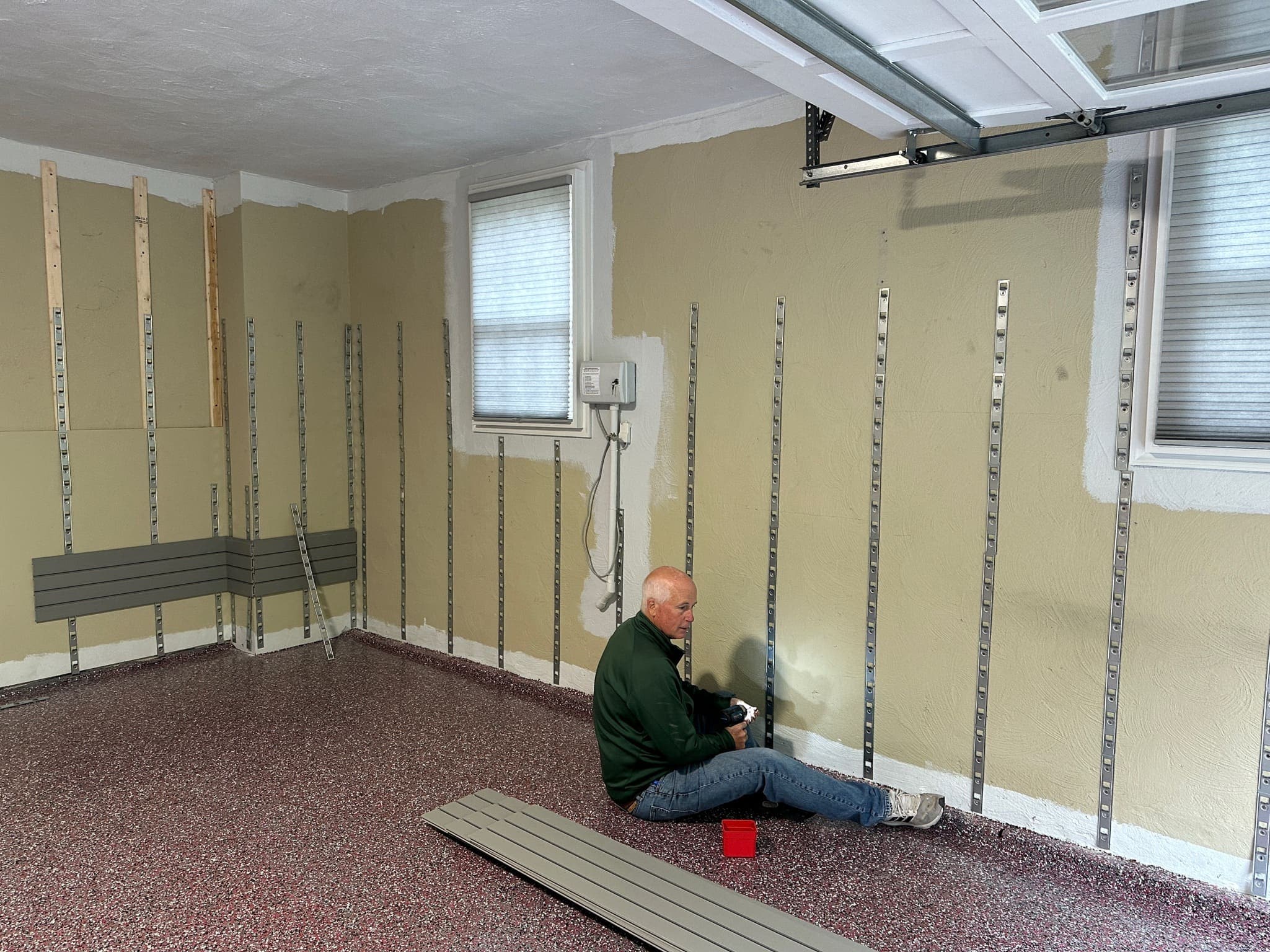 Day 4. Slat wall brackets go up with no screws visible. Precision is key at this stage. Each bracket is placed so the slats will sit level and support heavy loads without any visible hardware.